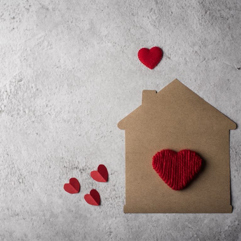 Paper house with heart flat design