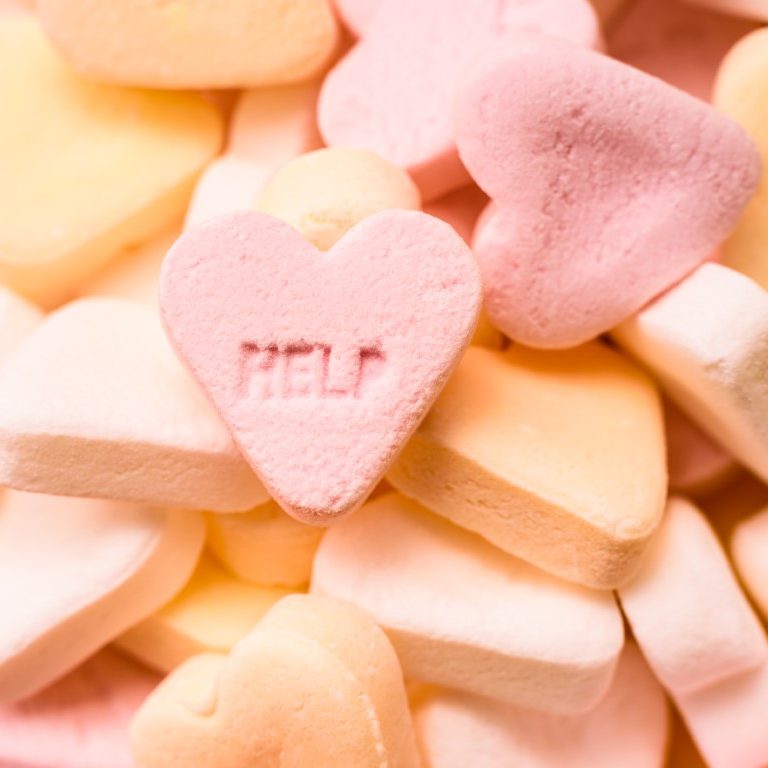 Word Help engraved in a sweet heart-shaped candy, couples therapy concept.
